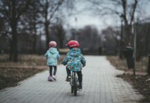 다이어트에 적합한 가을철 야외 운동 베스트 5 child riding with bike and another child walking on concrete pavement near trees