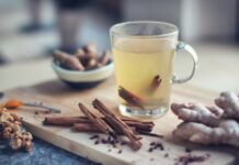 겨울철 건강을 위한 따뜻한 차의 효능 clear glass mug with yellow liquid on brown wooden chopping board