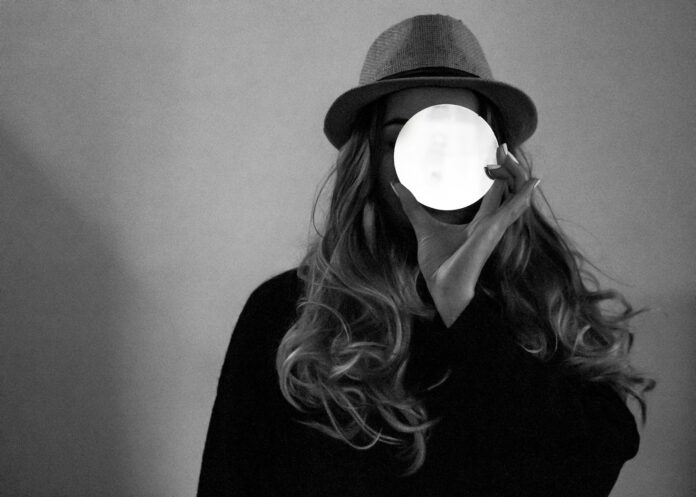 Photo by Carolina woman in black shirt wearing black hat