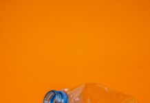 “플라스틱 줄이기, 작은 실천으로 건강 지키는 비결” blue plastic bottle on orange surface