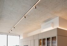 만성피로, 생활 속 루틴이 해법… ‘슬로우 라이프’로 활력 더하기 Modern dining room with large table and wine cabinet.