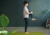 근육 건강, 집에서도 쉽게 챙긴다…일상 속 실천법 인기 Woman practicing yoga on a green mat indoors.
